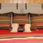 lakeside-living-design-northwoods-wi-cabin-decor-patterned-pillows-reds-orange-brown-diamond-fabric